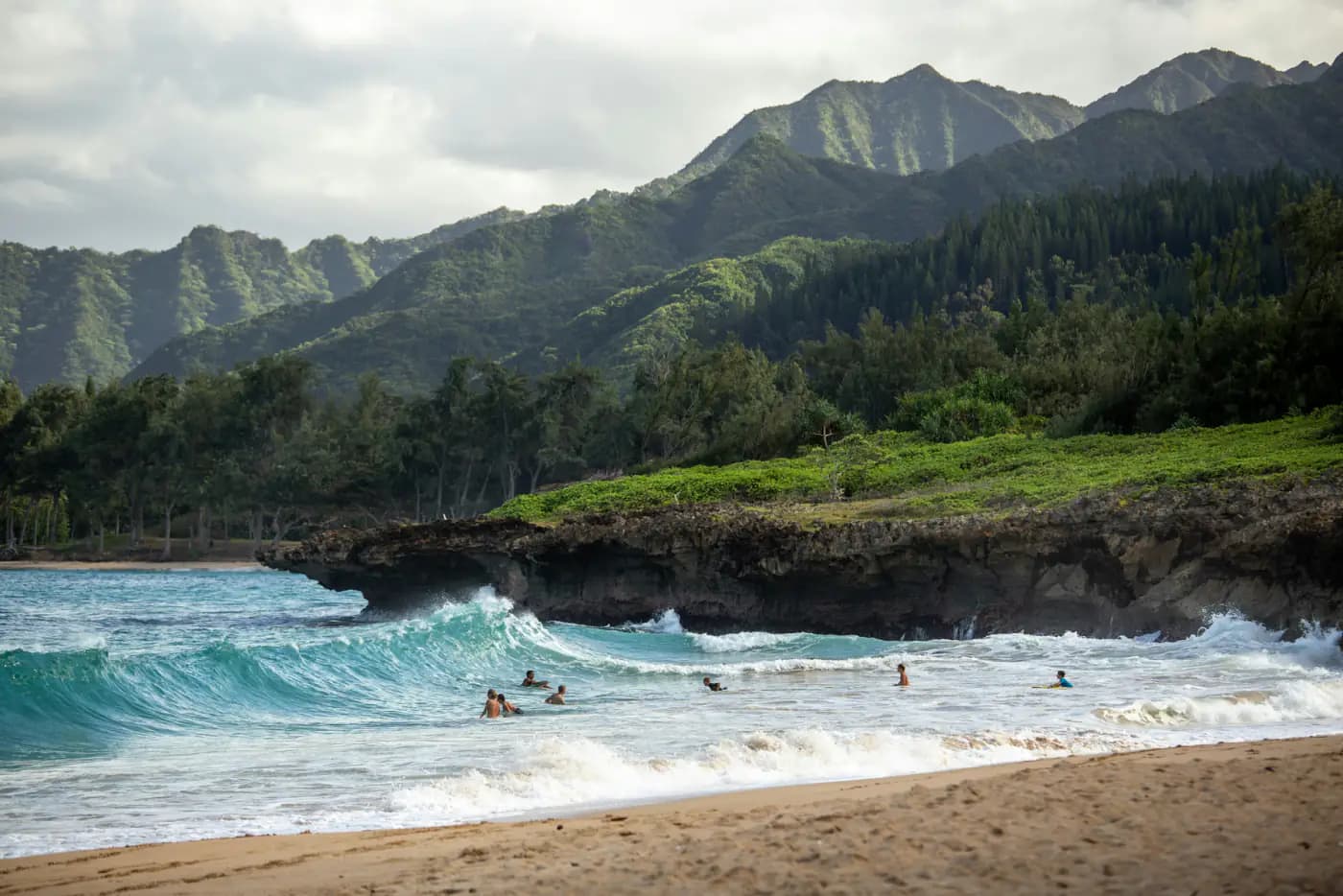 The front of the postcard: the photo printed edge to edge, here a Hawaii beach with green mountains behind the waves.